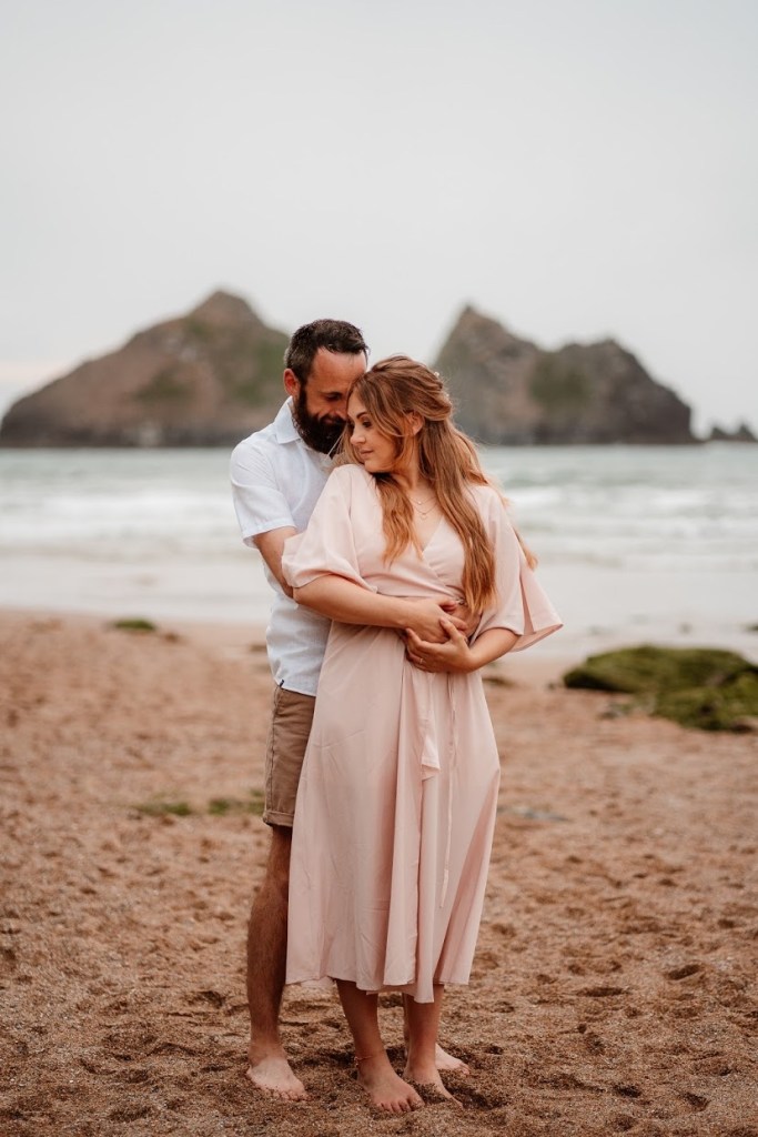 couple cuddling on the beach