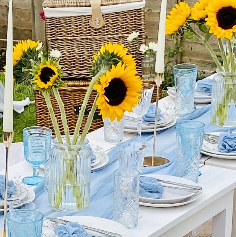 Blue picnic setup with sunflowers